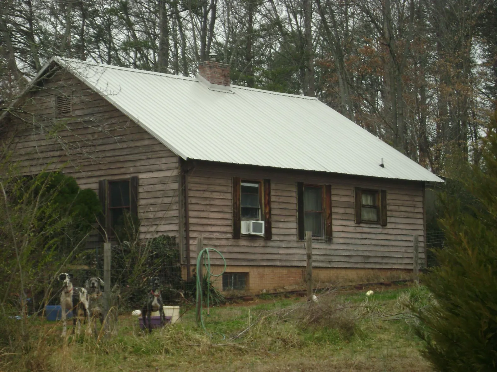 White metal roof on an old wood sided farmhouse, from a Metal Roof Installation job in Shavertown